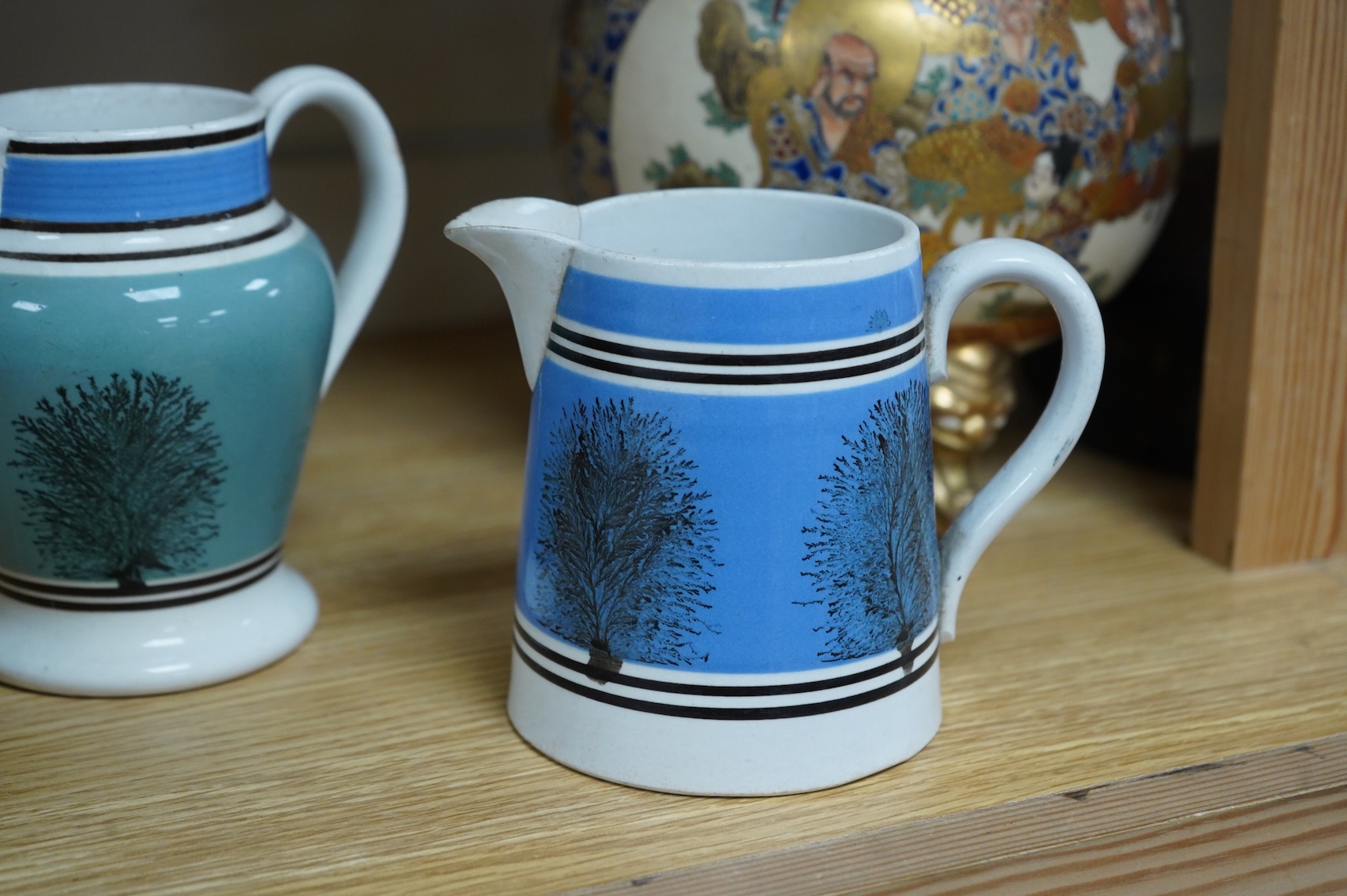 Two early 19th century Mocha ware jugs and two mugs, largest 16cm high